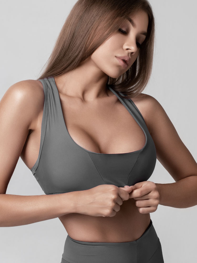 Female model with large breasts wearing sports undergarments.