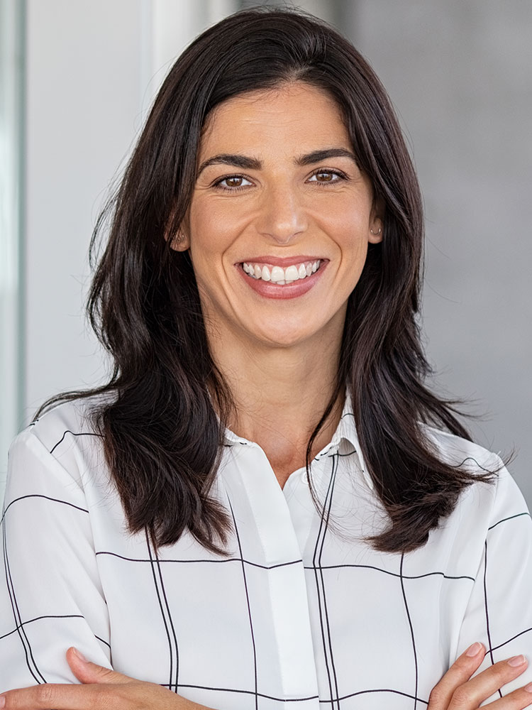 Headshot of a smiling woman with long dark hair