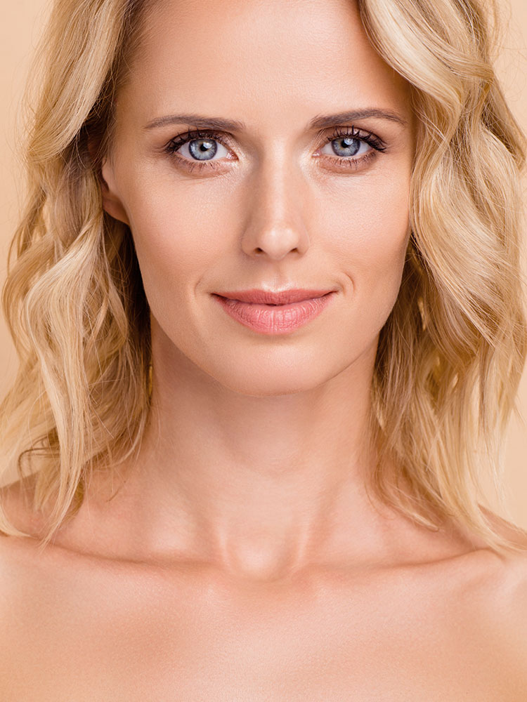 Headshot of a blonde woman with slim facial features