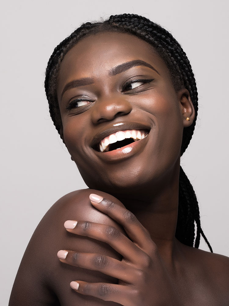 Young adult Black woman happily looking back over her shoulder