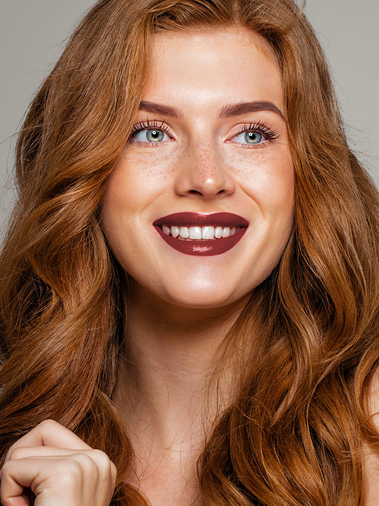 Headshot of a woman with red lipstick